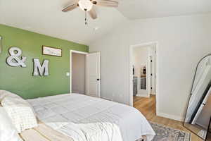 Bedroom featuring ceiling fan, vaulted ceiling, and light hardwood / wood-style flooring