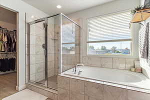 Bathroom featuring independent shower and bath and hardwood / wood-style floors