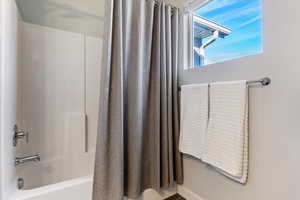 Bathroom featuring shower / bath combo with shower curtain