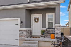 Doorway to property with a garage