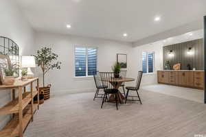 Carpeted dining room with sink