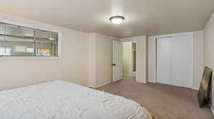 Bedroom featuring a closet and light carpet