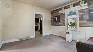 Interior space featuring wood walls and a textured ceiling