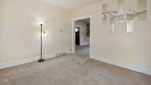 Unfurnished room featuring light colored carpet