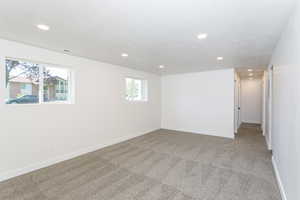 Carpeted empty room with a textured ceiling