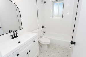 Full bathroom featuring vanity, toilet, and tub / shower combination