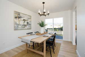 Dining area featuring a notable chandelier and light wood-type flooring