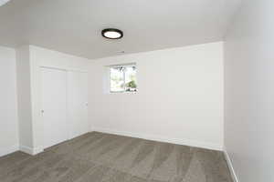 Unfurnished bedroom with a closet, a textured ceiling, and carpet flooring