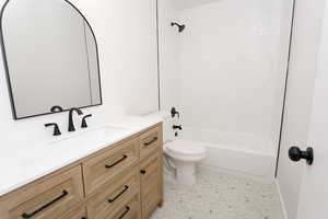 Full bathroom featuring vanity, toilet, and bathing tub / shower combination