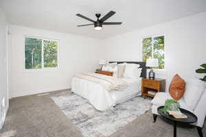 Carpeted bedroom with ceiling fan