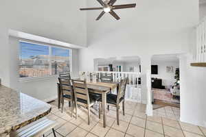 Dining area featuring light tile patterned floors and ceiling fan