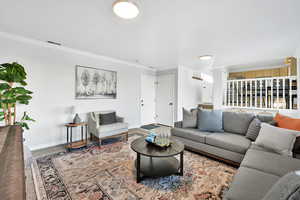 Living room featuring crown molding