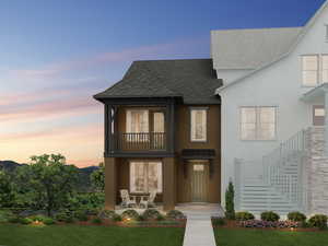 View of front of home featuring a patio, a lawn, and a balcony