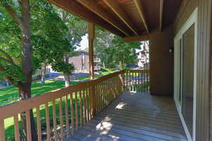 Wooden terrace featuring a yard