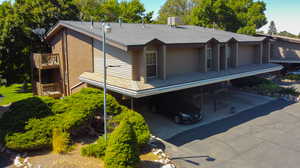 Back of property featuring a carport and a balcony