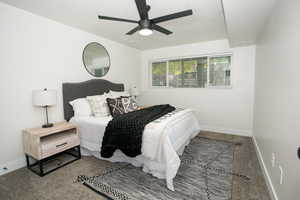 Carpeted bedroom featuring ceiling fan