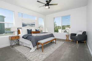 Carpeted bedroom with multiple windows and ceiling fan