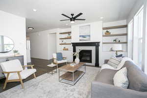 Living room with ceiling fan, a wealth of natural light, a tile fireplace, and hardwood / wood-style floors