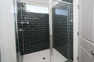 Bathroom featuring a shower with door