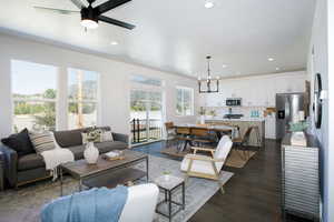 Living room with sink, ceiling fan with notable chandelier, and dark hardwood / wood-style flooring