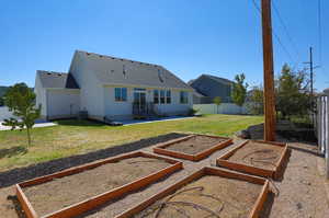 Rear view of property with a yard, central air condition unit, and a patio