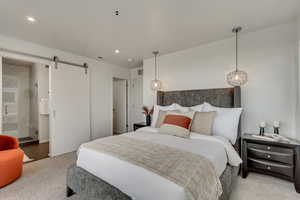 Bedroom featuring carpet floors and a barn door