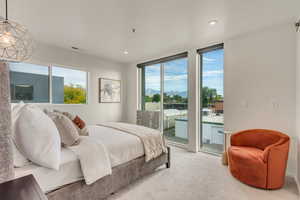 Bedroom with access to outside, multiple windows, and carpet floors