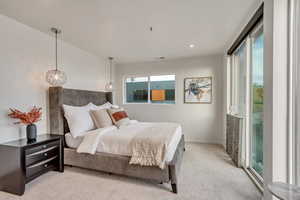 Bedroom featuring light colored carpet and access to outside