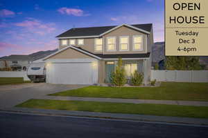 View of front of home featuring a yard and a garage