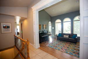 Living room featuring light hardwood / wood-style floors and vaulted ceiling