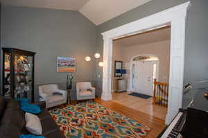 Living room featuring vaulted ceiling and light wood-type flooring