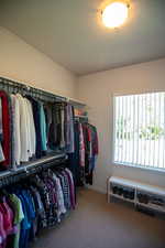 Master walk in closet featuring carpet flooring