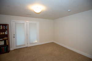 Carpeted bedroom with a textured ceiling