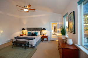 Master bedroom with vaulted ceiling, carpet flooring, and ceiling fan