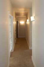 Corridor with light colored carpet