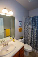 Bathroom featuring toilet, vanity, and tile patterned floors