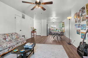 Living room featuring hardwood / wood-style floors and ceiling fan