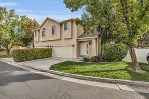 View of front of home featuring a front lawn and a garage