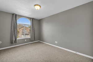 Carpeted bedroomroom with a textured ceiling