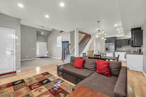 Living room with ceiling fan and light wood flooring