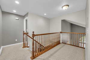 Corridor featuring carpet flooring