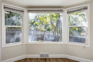 Unfurnished dining area featuring hardwood / wood-style floors