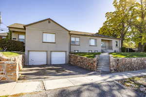 View of front of home featuring a garage and a front lawn