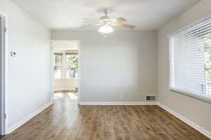 Empty room featuring hardwood / wood-style floors and ceiling fan