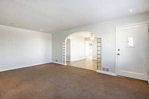 Empty room featuring ceiling fan, a textured ceiling, and light hardwood / wood-style floors