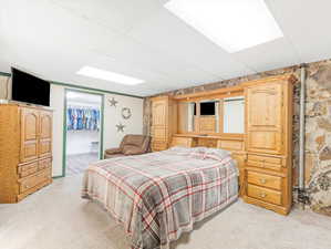 Carpeted bedroom featuring a closet and a paneled ceiling