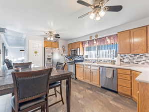 Kitchen with ceiling fan, tasteful backsplash, and appliances with stainless steel finishes