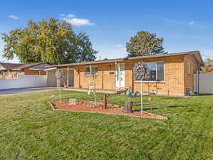 Single story home with a front yard and a patio area