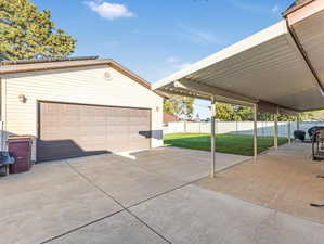 Garage featuring a lawn