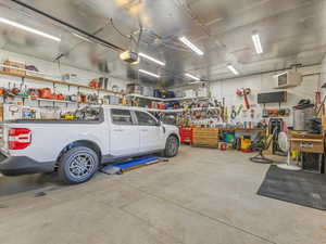 Garage with a garage door opener and a workshop area